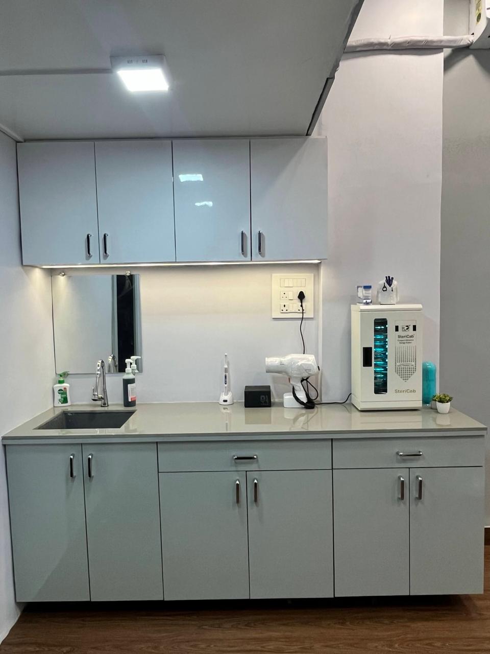 The sterilisation station at Evara, with autoclave cabinet, scrub sink and sealed instruments